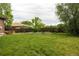 Expansive backyard featuring a lush lawn, a wooden fence and a garden at 654 S Shoshone St, Denver, CO 80223