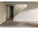 Finished basement with neutral paint, carpet, white trim, and an open stairwell at 654 S Shoshone St, Denver, CO 80223