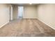 Large finished basement featuring neutral paint, carpet, and an open doorway at 654 S Shoshone St, Denver, CO 80223