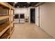 Unfinished basement with washer, dryer, utility sink, wooden shelving, and open ceiling at 654 S Shoshone St, Denver, CO 80223