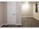 Finished basement with neutral paint, carpet, and an adjacent room visible through the doorway at 654 S Shoshone St, Denver, CO 80223
