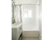Bright bathroom featuring a shower-tub combination, a window, and neutral-toned vanity at 654 S Shoshone St, Denver, CO 80223