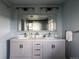 Bathroom featuring a double vanity with marble countertops and decorative lighting at 654 S Shoshone St, Denver, CO 80223