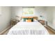 Cozy bedroom featuring a bed with wood headboard, stylish nightstands and a window at 654 S Shoshone St, Denver, CO 80223