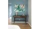 A desk with wood drawers, lamp, and artwork graces this room, set against a calming blue wall at 654 S Shoshone St, Denver, CO 80223