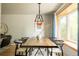 Stylish dining room featuring a modern light fixture and a large bay window at 654 S Shoshone St, Denver, CO 80223