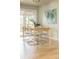 Bright dining room featuring a table and stylish chairs with an abstract painting on the wall at 654 S Shoshone St, Denver, CO 80223
