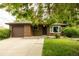 Charming brick home with a well-manicured lawn and a convenient attached garage at 654 S Shoshone St, Denver, CO 80223