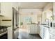 Modern kitchen with stainless steel appliances, white cabinetry, dark countertops, and an open layout at 654 S Shoshone St, Denver, CO 80223