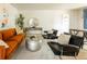 Bright living room showcasing a comfortable sofa, black chairs, and a modern silver coffee table on a light rug at 654 S Shoshone St, Denver, CO 80223