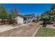 Exterior view of the backyard with a fire pit, partial xeriscaping, and a charming two-story home at 3256 S Nucla St, Aurora, CO 80013