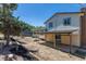 Backyard featuring a covered patio, mulched flowerbeds, and ample space, great for outdoor living and landscaping at 3256 S Nucla St, Aurora, CO 80013