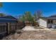 Fenced backyard with a concrete patio area next to the home, creating a private outdoor space at 3256 S Nucla St, Aurora, CO 80013