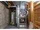 Utility area in the basement features a water heater, furnace, and open shelving for storage at 3256 S Nucla St, Aurora, CO 80013