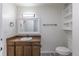A bright bathroom has a wood vanity and classic fixtures at 3256 S Nucla St, Aurora, CO 80013