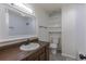A bathroom with a dark wood vanity and ample shelving for storage at 3256 S Nucla St, Aurora, CO 80013