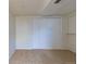 A simple bedroom features a neutral color palette and a closet for storage at 3256 S Nucla St, Aurora, CO 80013