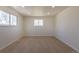 A bright bedroom with neutral carpet, a large window letting in natural light, and freshly painted white walls at 3256 S Nucla St, Aurora, CO 80013