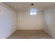 A simple bedroom with carpet and a small window for light at 3256 S Nucla St, Aurora, CO 80013