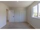 An airy bedroom includes carpet, a window and closet for storage at 3256 S Nucla St, Aurora, CO 80013