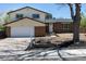 Traditional two-story home featuring brick accents, white siding, and an attached two-car garage at 3256 S Nucla St, Aurora, CO 80013