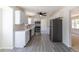 Modern kitchen with white cabinets, stainless steel appliances, gray wood-look flooring, and a ceiling fan at 3256 S Nucla St, Aurora, CO 80013