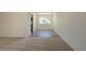 Inviting living area boasts a mix of carpet and wood flooring, plus large bright window at 3256 S Nucla St, Aurora, CO 80013