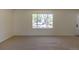 Bright living room features a large window offering neighborhood views and neutral carpeting at 3256 S Nucla St, Aurora, CO 80013