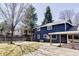 Exterior of home showcases a spacious backyard with a covered patio and lush green grass at 3100 S Holly Pl, Denver, CO 80222