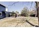 Expansive backyard featuring a covered patio, mature trees, and a well-maintained lawn at 3100 S Holly Pl, Denver, CO 80222