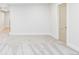 Carpeted bedroom features tan door, white baseboards, and neutral paint at 3100 S Holly Pl, Denver, CO 80222