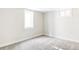Carpeted bedroom features white baseboards, two windows, and neutral paint at 3100 S Holly Pl, Denver, CO 80222