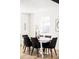 Bright dining room with modern table set, stylish decor, and a large window at 3100 S Holly Pl, Denver, CO 80222