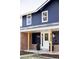 Inviting exterior featuring a blue facade, brick accents, and a welcoming front porch with visible house number at 3100 S Holly Pl, Denver, CO 80222