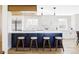 Modern kitchen featuring a navy blue island, white cabinets, and stylish pendant lighting at 3100 S Holly Pl, Denver, CO 80222