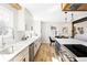 Stylish kitchen with white cabinets, marble countertops, stainless steel appliances, and hardwood floors at 3100 S Holly Pl, Denver, CO 80222
