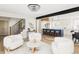 Open-concept living area with hardwood floors, stylish decor, and a view into the kitchen and dining area at 3100 S Holly Pl, Denver, CO 80222