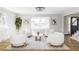 Bright living room with stylish furnishings, hardwood floors, and a large window overlooking the front yard at 3100 S Holly Pl, Denver, CO 80222