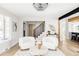 Cozy living room featuring hardwood floors, white walls, and a staircase with black metal railings at 3100 S Holly Pl, Denver, CO 80222
