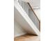 Contemporary staircase boasting modern black metal railings, wooden banister and light wooden steps at 3100 S Holly Pl, Denver, CO 80222