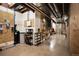 Unfinished basement with exposed pipes, utilities, and storage shelves, providing ample space at 8294 Wild Timber Dr, Franktown, CO 80116