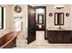 Bathroom boasting a soaking tub, double vanity, tiled floor and an open doorway to a bedroom area at 8294 Wild Timber Dr, Franktown, CO 80116