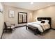 Bedroom with decorative bed frame, bench, chair, and picturesque windows at 8294 Wild Timber Dr, Franktown, CO 80116