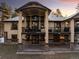 Beautiful back of house featuring a large balcony, stone accents, and an arched entryway at 8294 Wild Timber Dr, Franktown, CO 80116