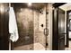 Glass enclosed shower with tiled walls, decorative niche, and tiled floor at 8294 Wild Timber Dr, Franktown, CO 80116