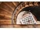 Unique wrought iron and wood spiral staircase with adjacent chess table and checkers at 8294 Wild Timber Dr, Franktown, CO 80116