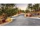 Gated community entrance with stone pillars and signage, ensuring privacy and exclusivity at 8294 Wild Timber Dr, Franktown, CO 80116