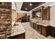 Wet bar features granite counters, wine storage and under counter refrigerators at 8294 Wild Timber Dr, Franktown, CO 80116