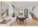 Bright dining room showcases modern lighting, large windows, and seamless access to the staircase at 4487 Utica St, Denver, CO 80211