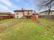 Expansive backyard with a wooden deck and staircase, set against a lush green lawn at 1045 Mobile St, Aurora, CO 80011